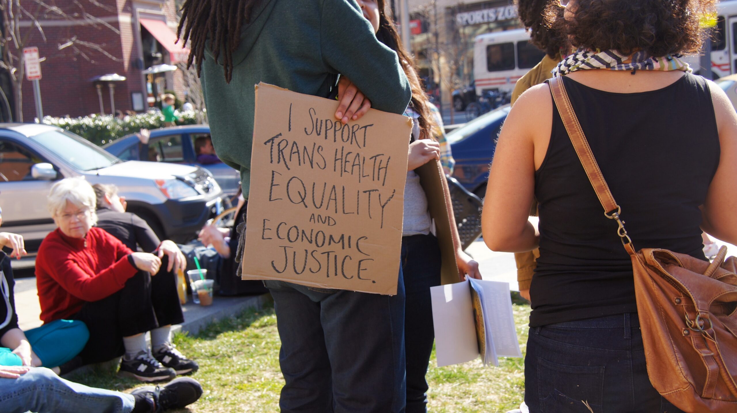Sign at a transgender equality rally reading I support trans health equality and economic justice